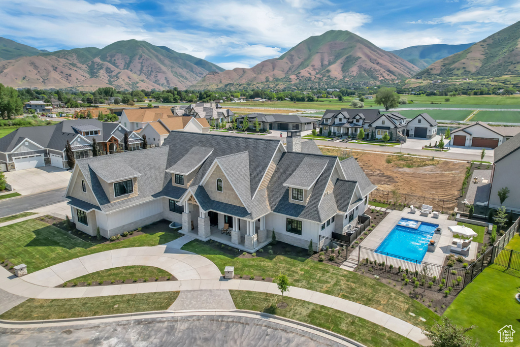 Aerial perspective of suburban area with a pool and a mountainous background