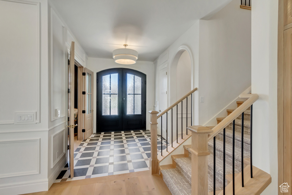 Foyer entrance with french doors and stairs