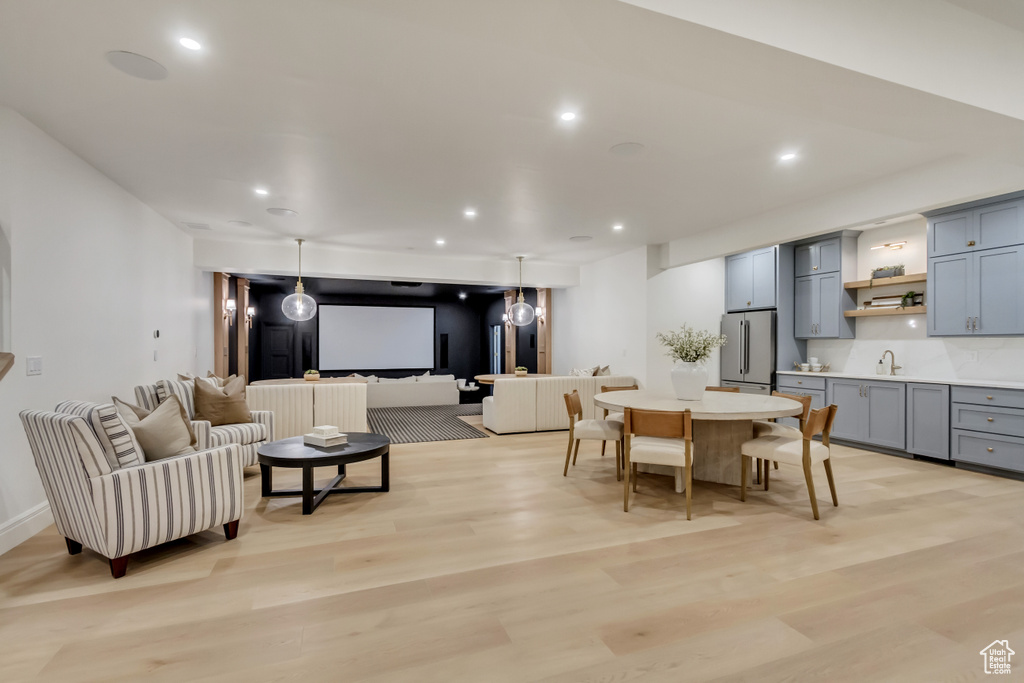 Dining room with light wood finished floors and recessed lighting