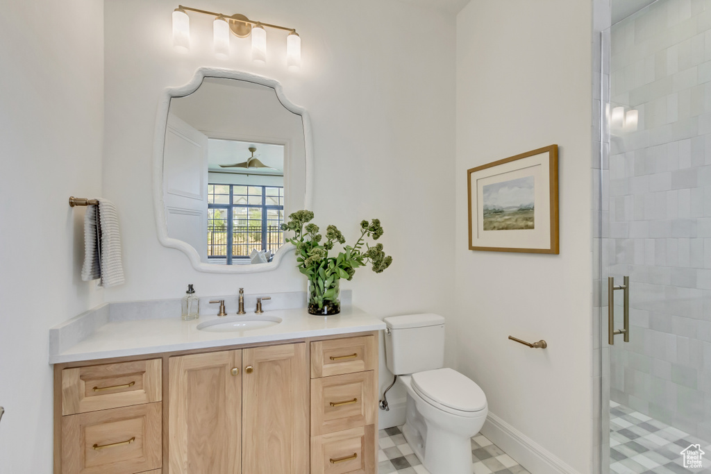 Bathroom with a stall shower, vanity, and tile patterned flooring