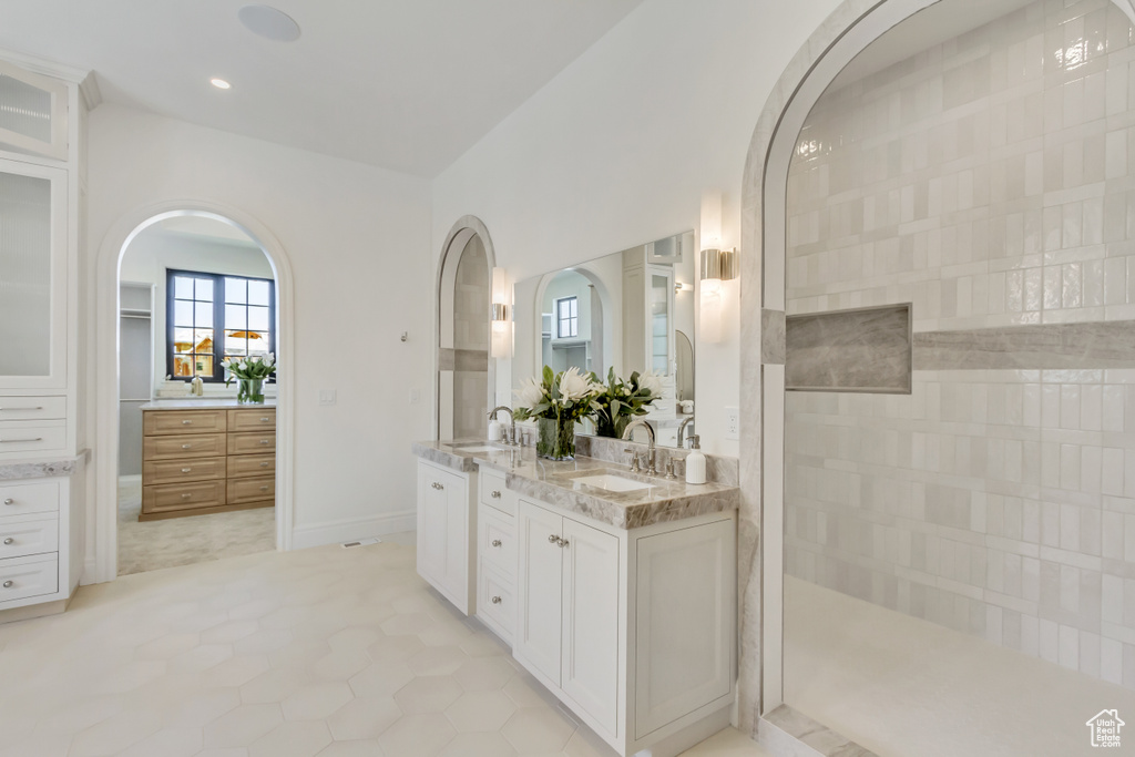 Bathroom with double vanity, recessed lighting, tile patterned floors, and a walk in shower