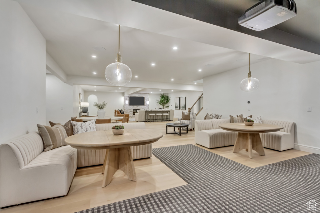 Living room with stairway, recessed lighting, and light wood finished floors