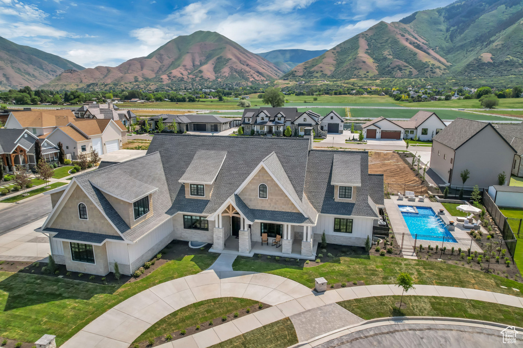 Aerial perspective of suburban area with mountains and a pool
