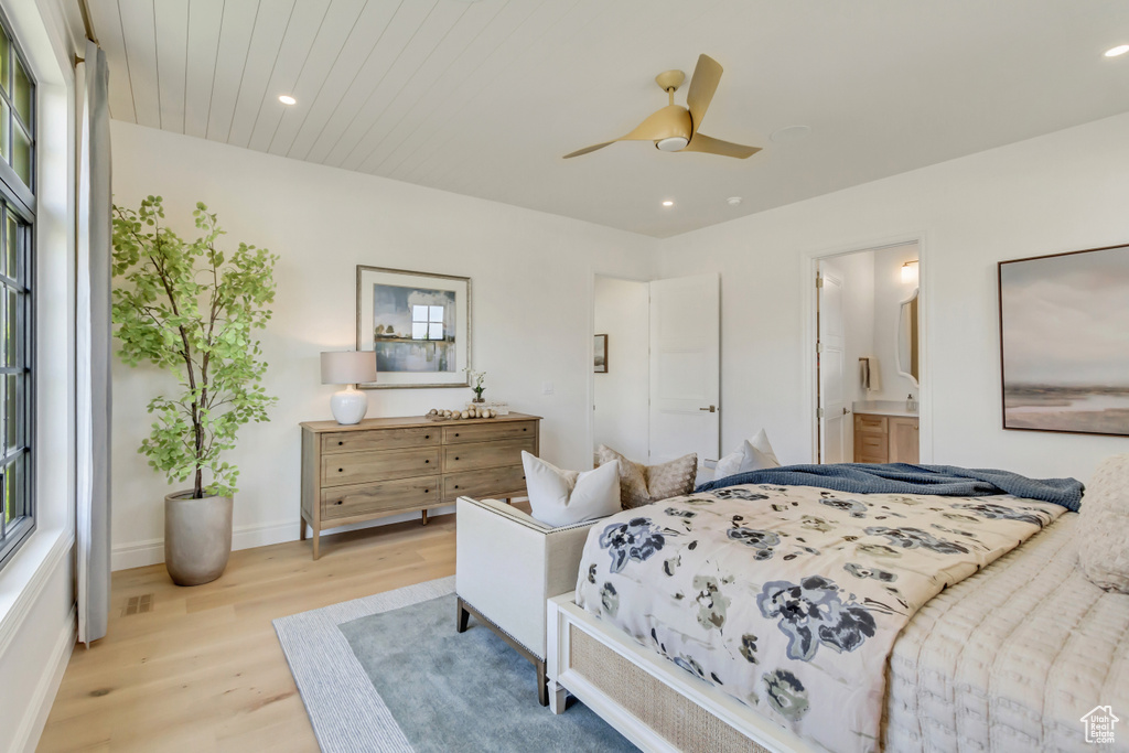 Bedroom featuring light wood finished floors, recessed lighting, multiple windows, connected bathroom, and a ceiling fan