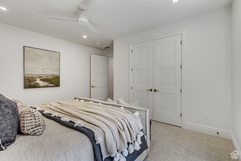 Bedroom with recessed lighting, light colored carpet, ceiling fan, and a closet