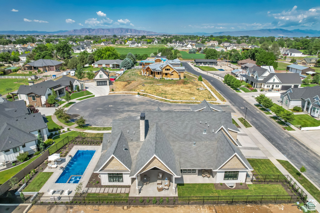 Aerial perspective of suburban area with a pool area and a mountain backdrop