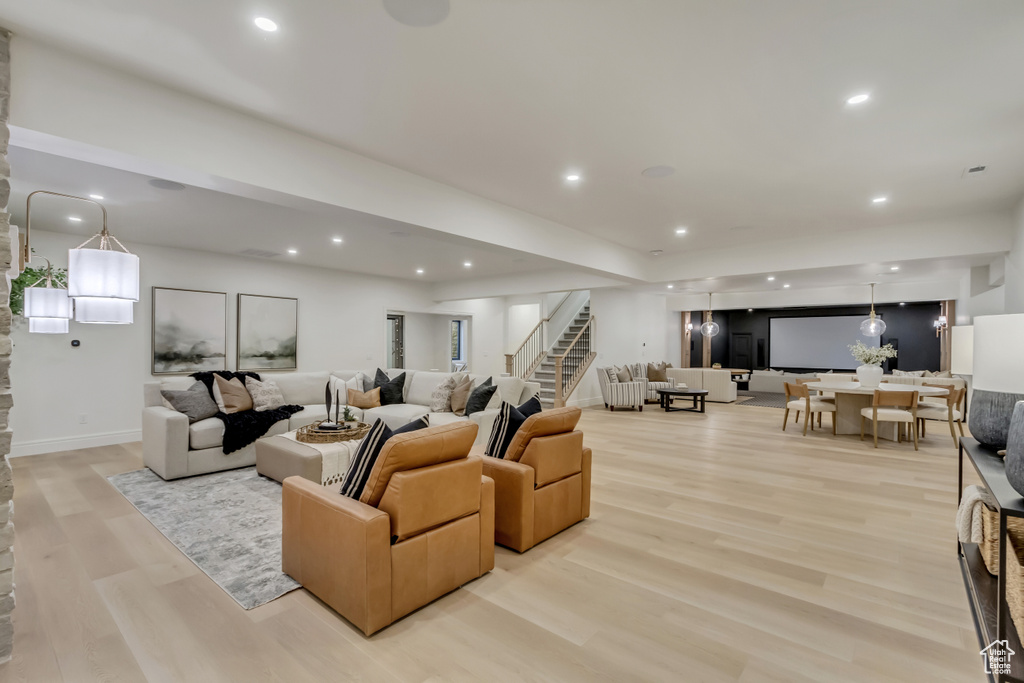 Living area featuring stairway, light wood finished floors, and recessed lighting