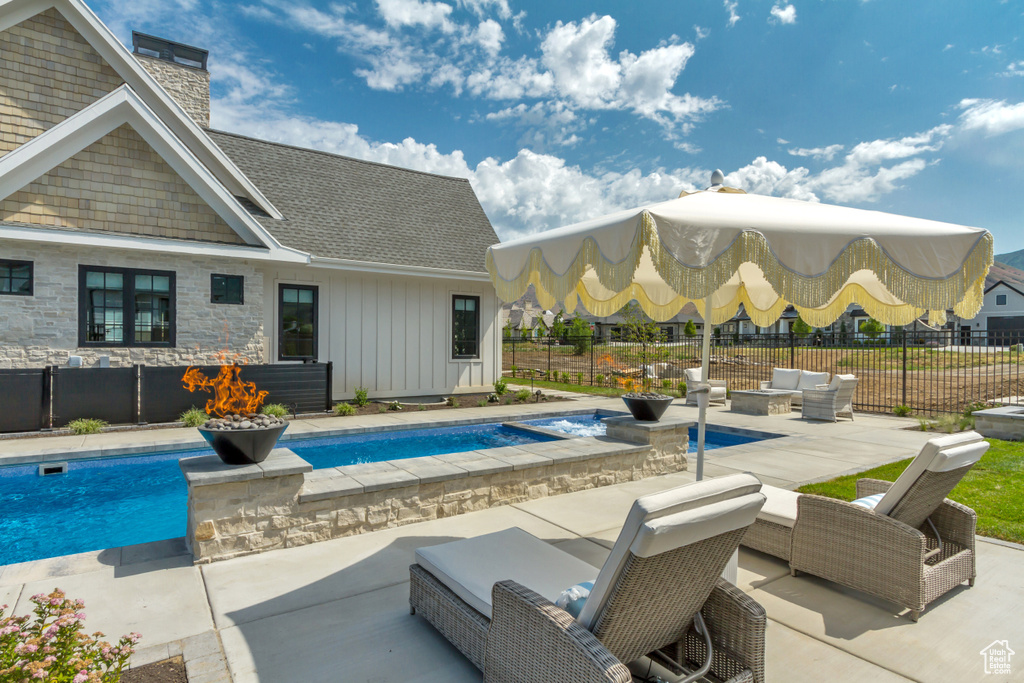 View of swimming pool with a patio and an outdoor living space