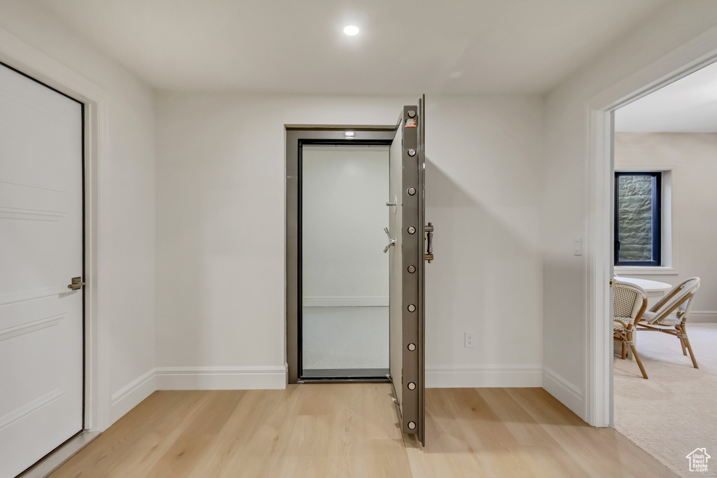 Foyer entrance with light wood-style floors and recessed lighting