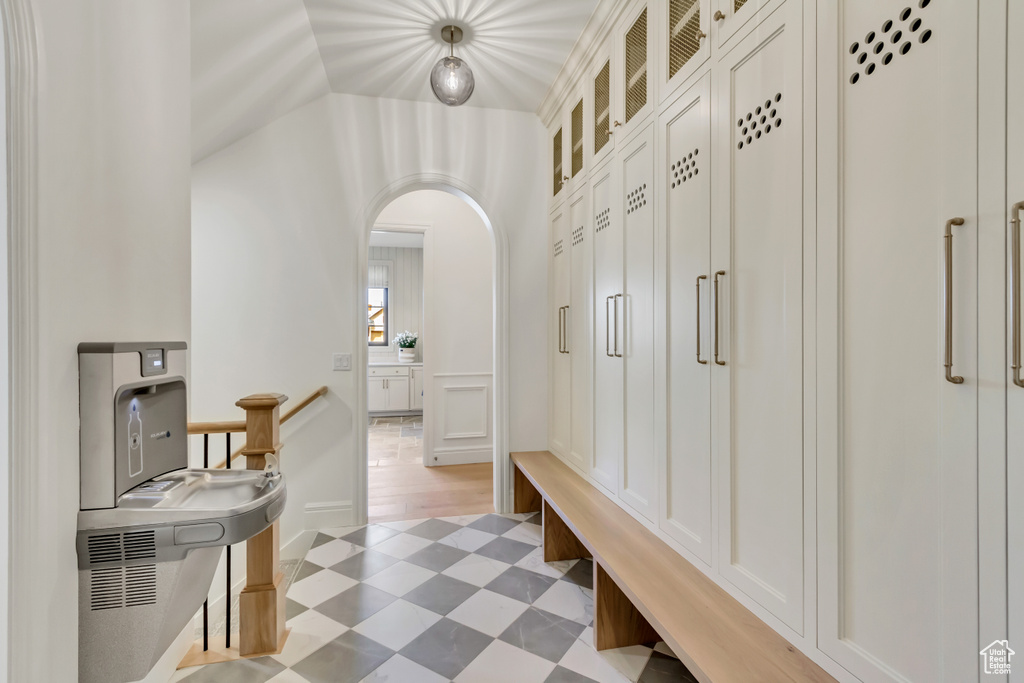 Mudroom featuring light flooring and arched walkways