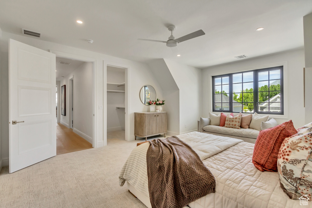 Bedroom featuring recessed lighting, light carpet, ceiling fan, a spacious closet, and a closet