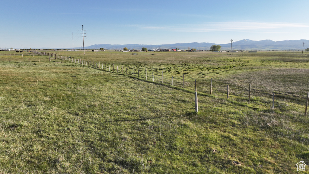 View of yard with a rural view and a mountain view