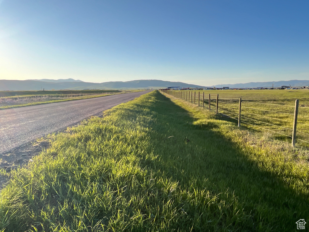 View of asphalt road featuring a mountain view and a view of countryside