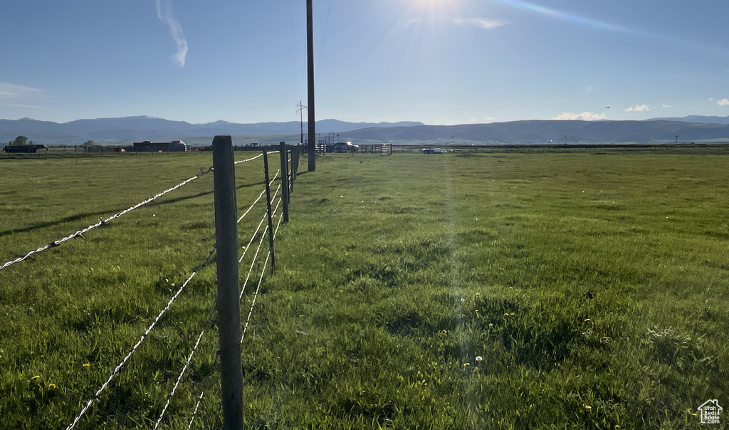 View of mountain backdrop featuring rural landscape and agricultural land