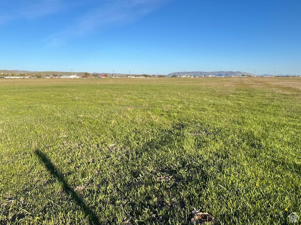 View of green lawn with a rural view
