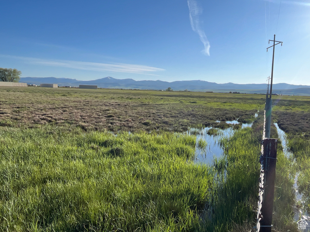 View of mountain background with rural landscape and a nearby body of water