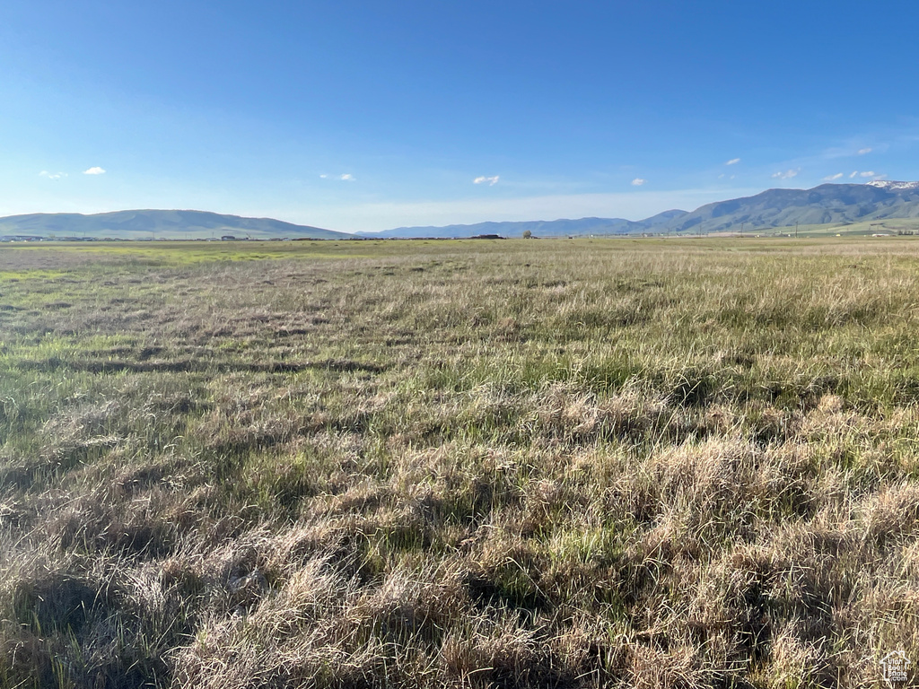 View of mountain backdrop with rural landscape