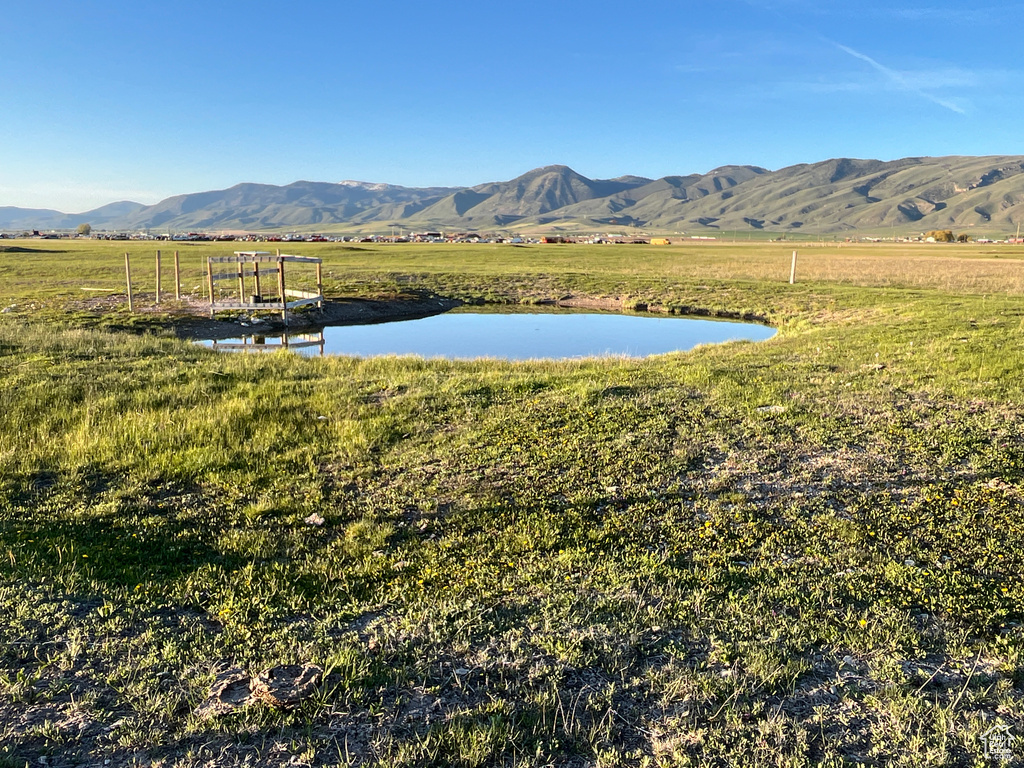 Mountain view featuring a large body of water and rural landscape