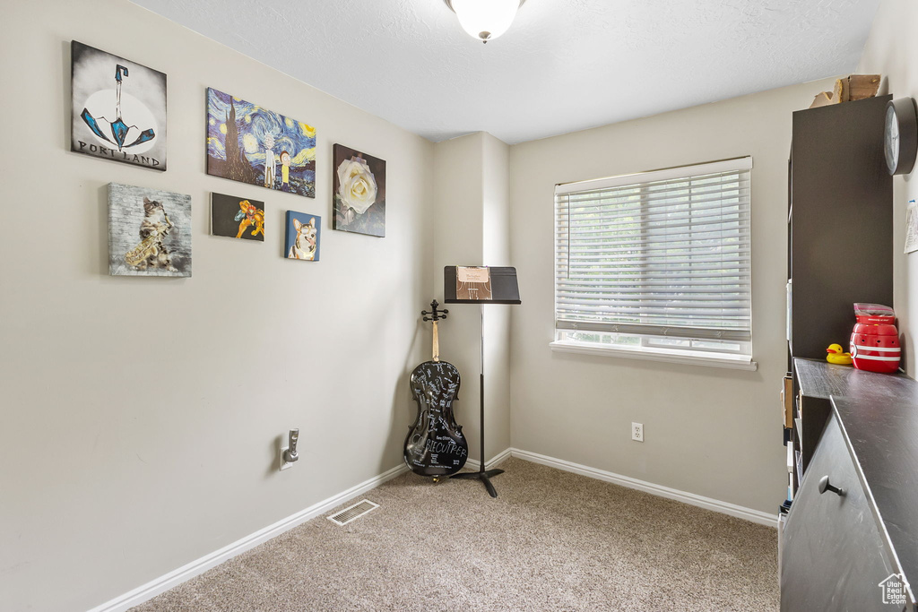 Misc room with carpet floors and baseboards