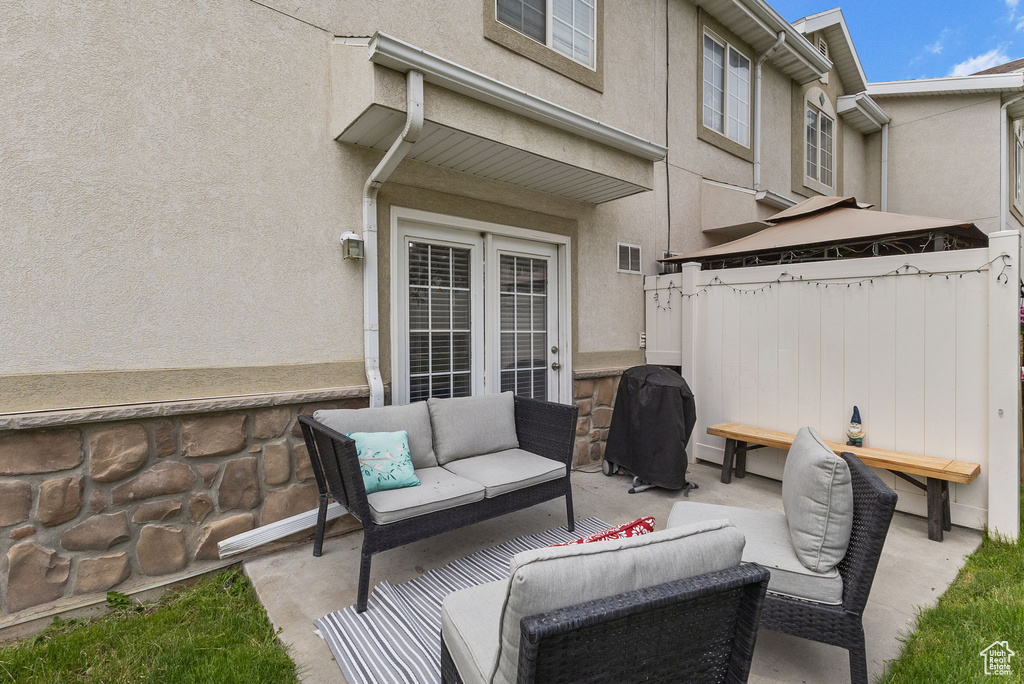 View of patio with outdoor lounge area, area for grilling, and a gazebo