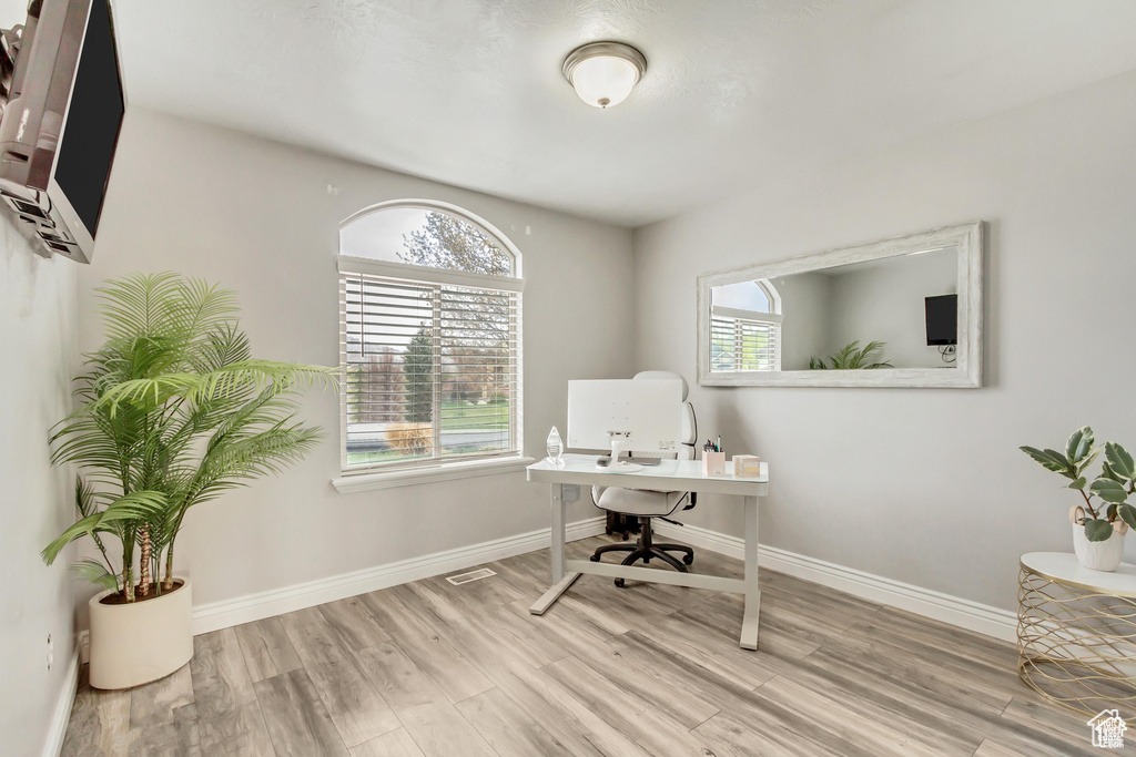 Office space with wood finished floors and baseboards