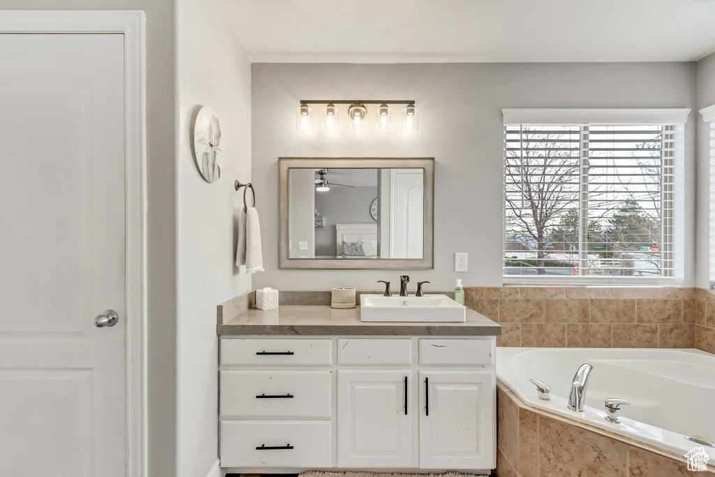 Full bathroom with vanity, a bath, and ceiling fan