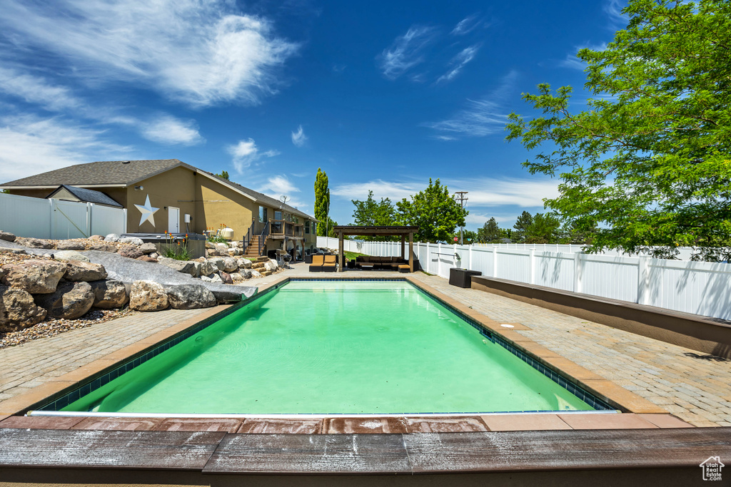 View of pool featuring a fenced backyard and a patio