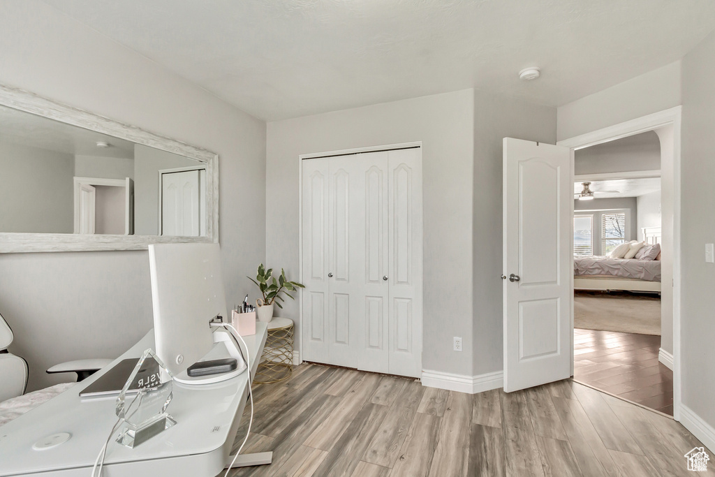 Office area featuring wood finished floors, baseboards, and ceiling fan