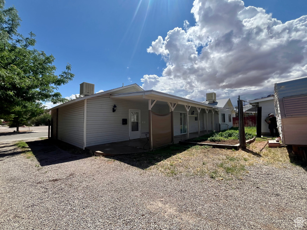 Rear view of property featuring central air condition unit