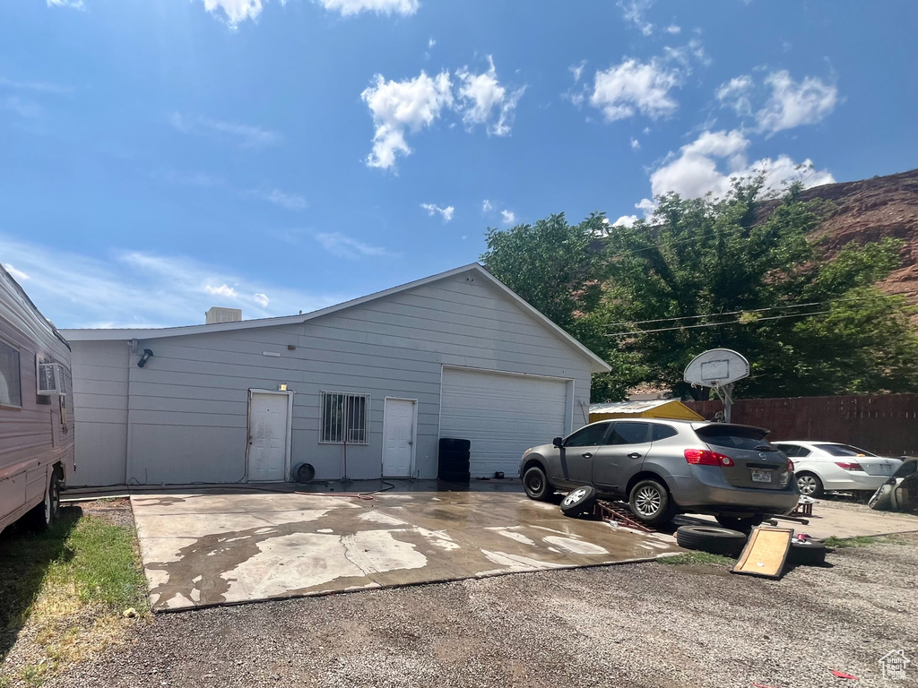 View of side of home with a garage and concrete driveway