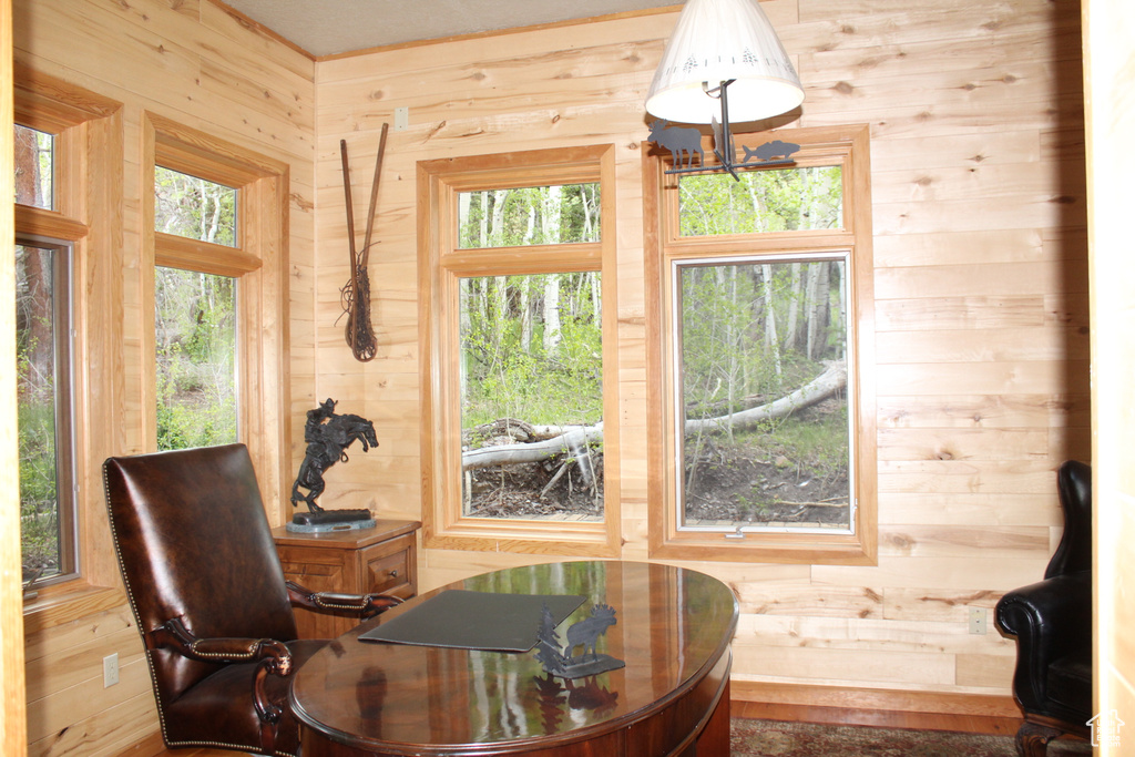 Dining space with wooden walls and a chandelier
