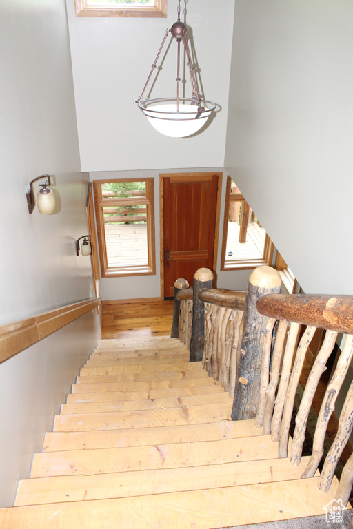 Stairway featuring wood finished floors
