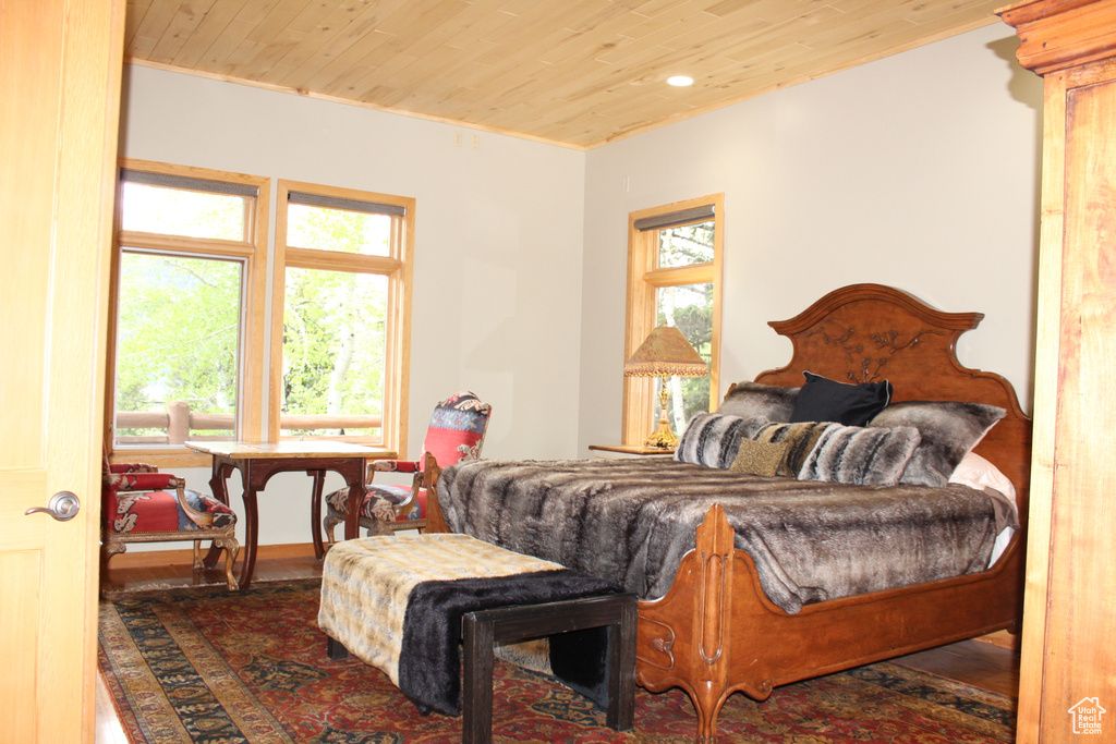 Bedroom with wood ceiling, wood finished floors, and recessed lighting