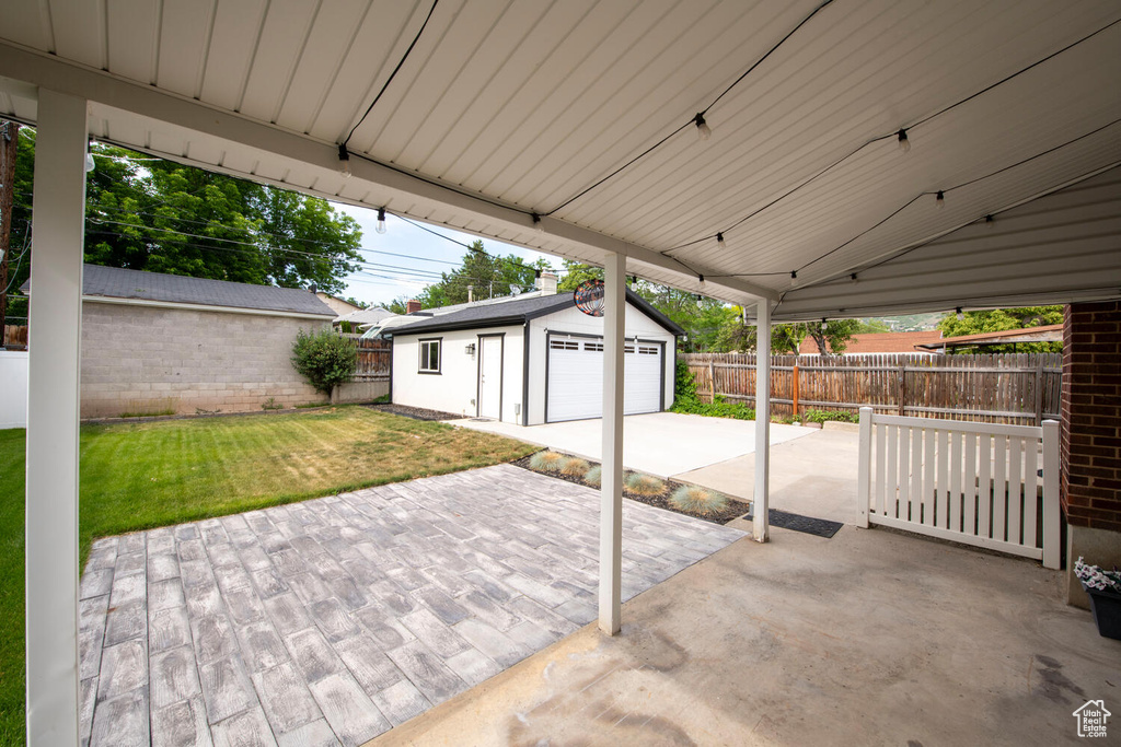 View of patio / terrace with a garage and an outdoor structure