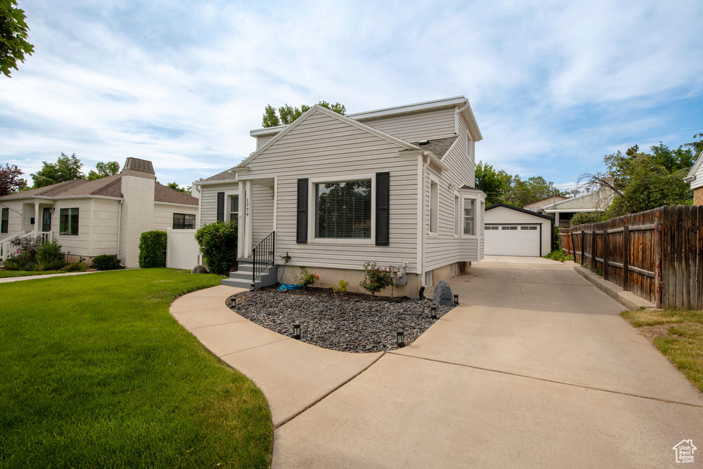 View of front of home featuring a garage, an outbuilding, and entry steps