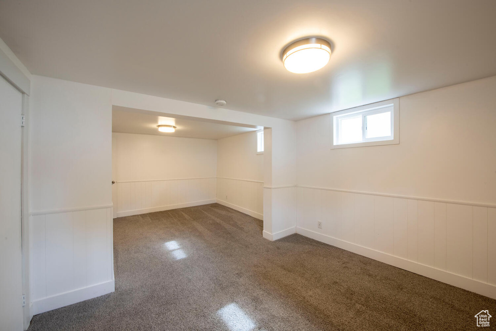 Basement with carpet floors and wainscoting