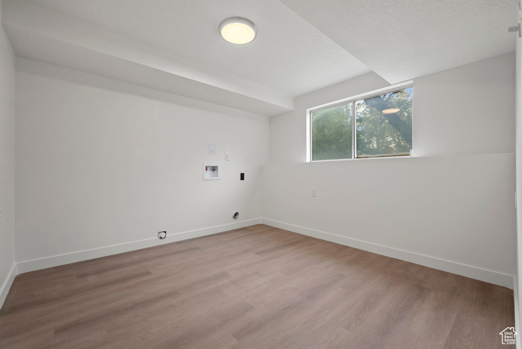 Empty room with light wood-style floors and baseboards