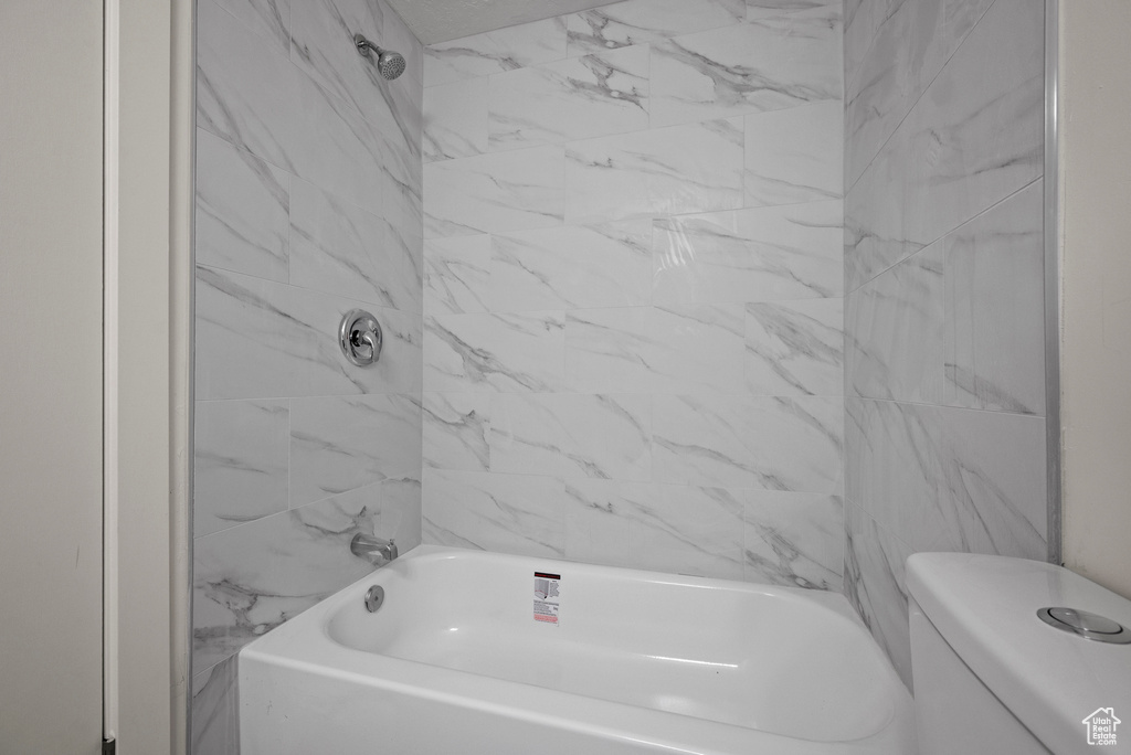 Full bathroom with toilet and tub / shower combination