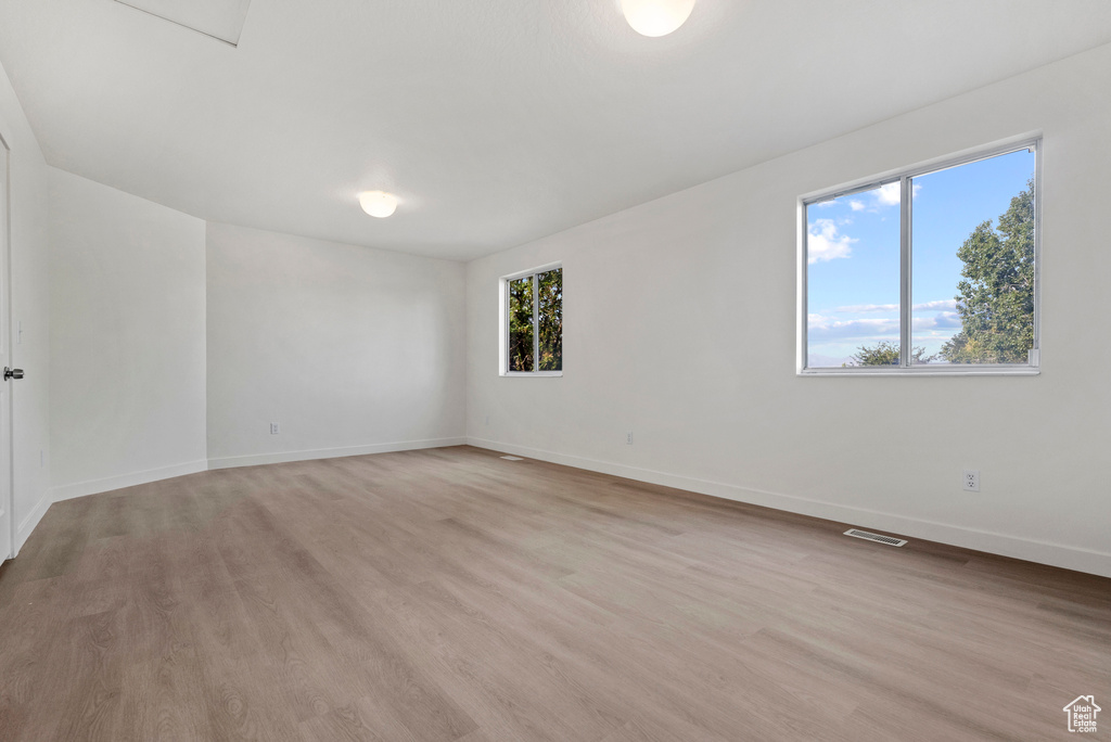 Empty room with baseboards and light wood finished floors