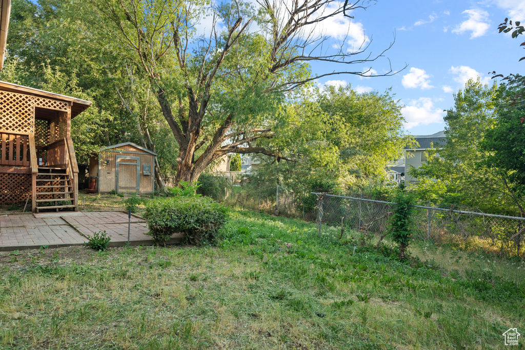 View of yard featuring a deck and stairway