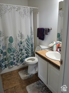 Bathroom featuring vanity, tile patterned floors, and shower / tub combo with curtain