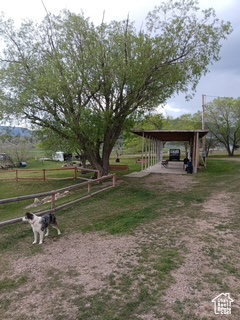View of yard with a carport and a rural view
