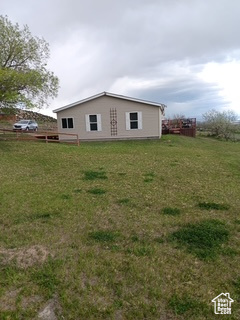 View of property exterior featuring a lawn