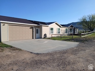 Ranch-style house with concrete driveway and a garage