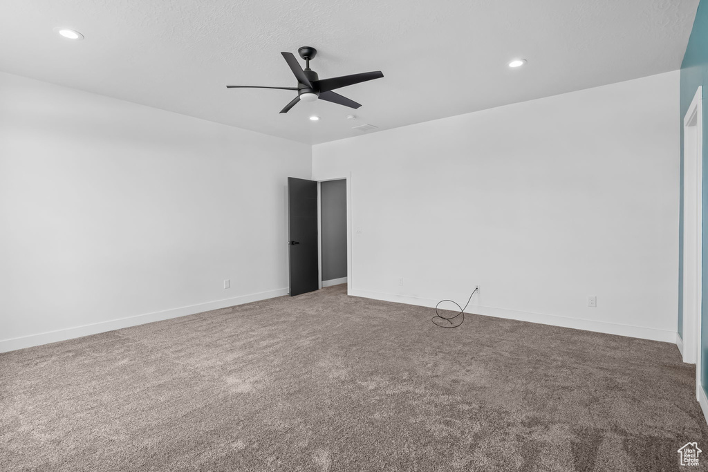 Empty room featuring a ceiling fan, carpet floors, recessed lighting, and baseboards