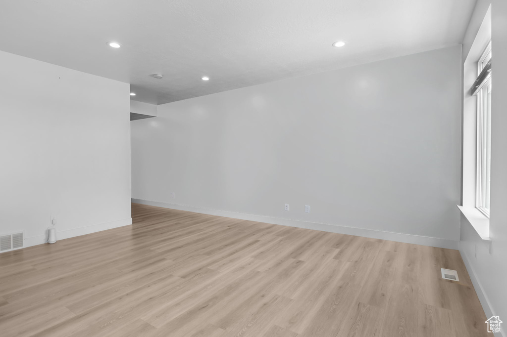Unfurnished room with light wood-style flooring, recessed lighting, and baseboards