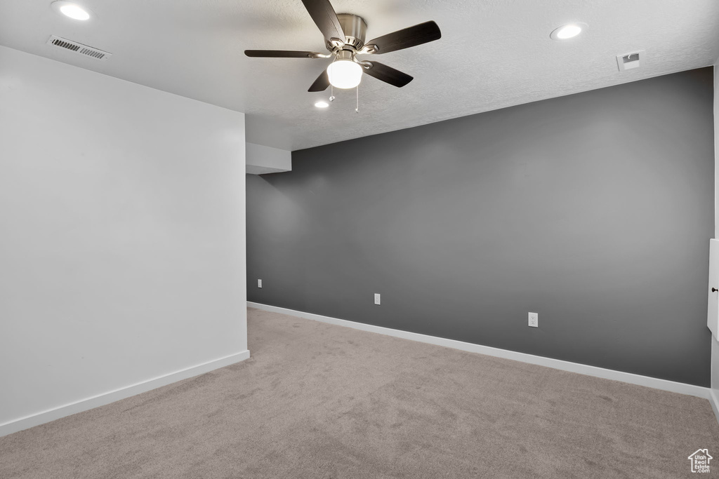 Spare room featuring ceiling fan, recessed lighting, carpet floors, and baseboards