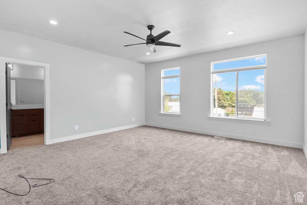 Empty room featuring baseboards, carpet flooring, a ceiling fan, and recessed lighting