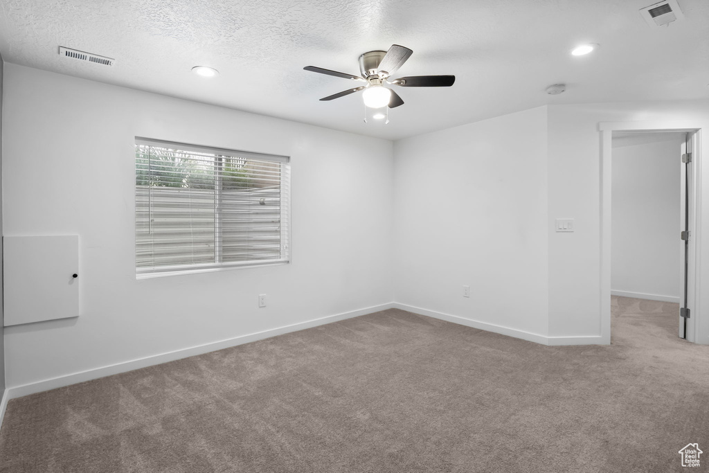 Unfurnished room featuring ceiling fan, carpet flooring, baseboards, recessed lighting, and a textured ceiling