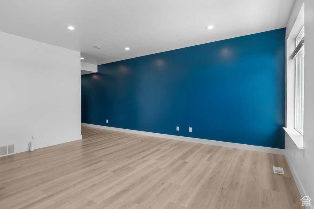 Spare room featuring wood finished floors, recessed lighting, and baseboards